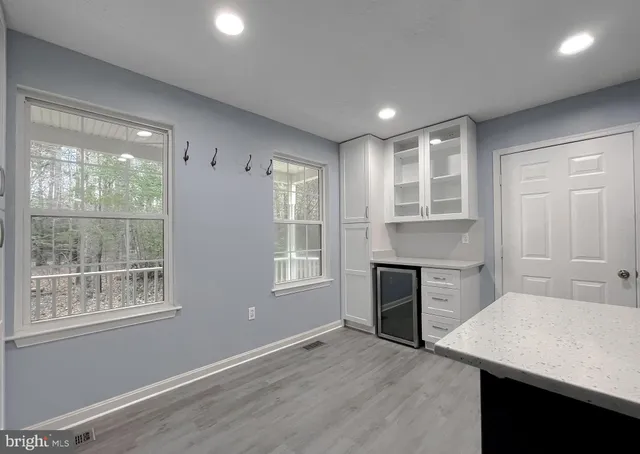 a spacious bedroom with a bed and a chandelier