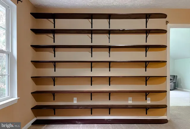 a view of an empty room with a ceiling fan