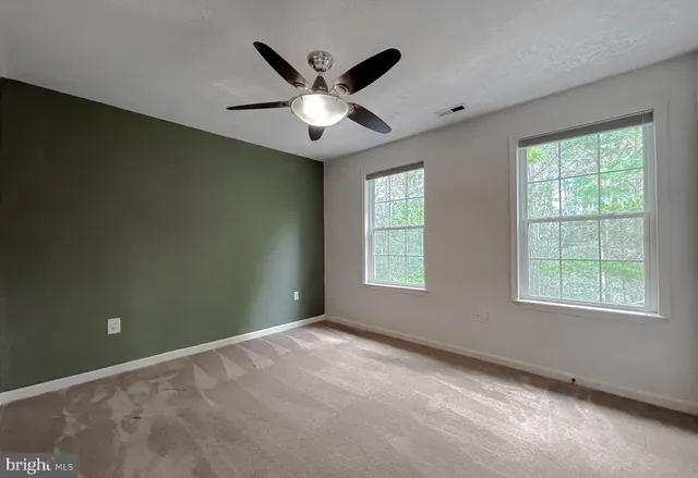 a view of an empty room with sliding glass door