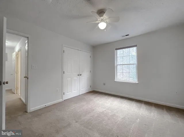 a view of a yard with wooden fence