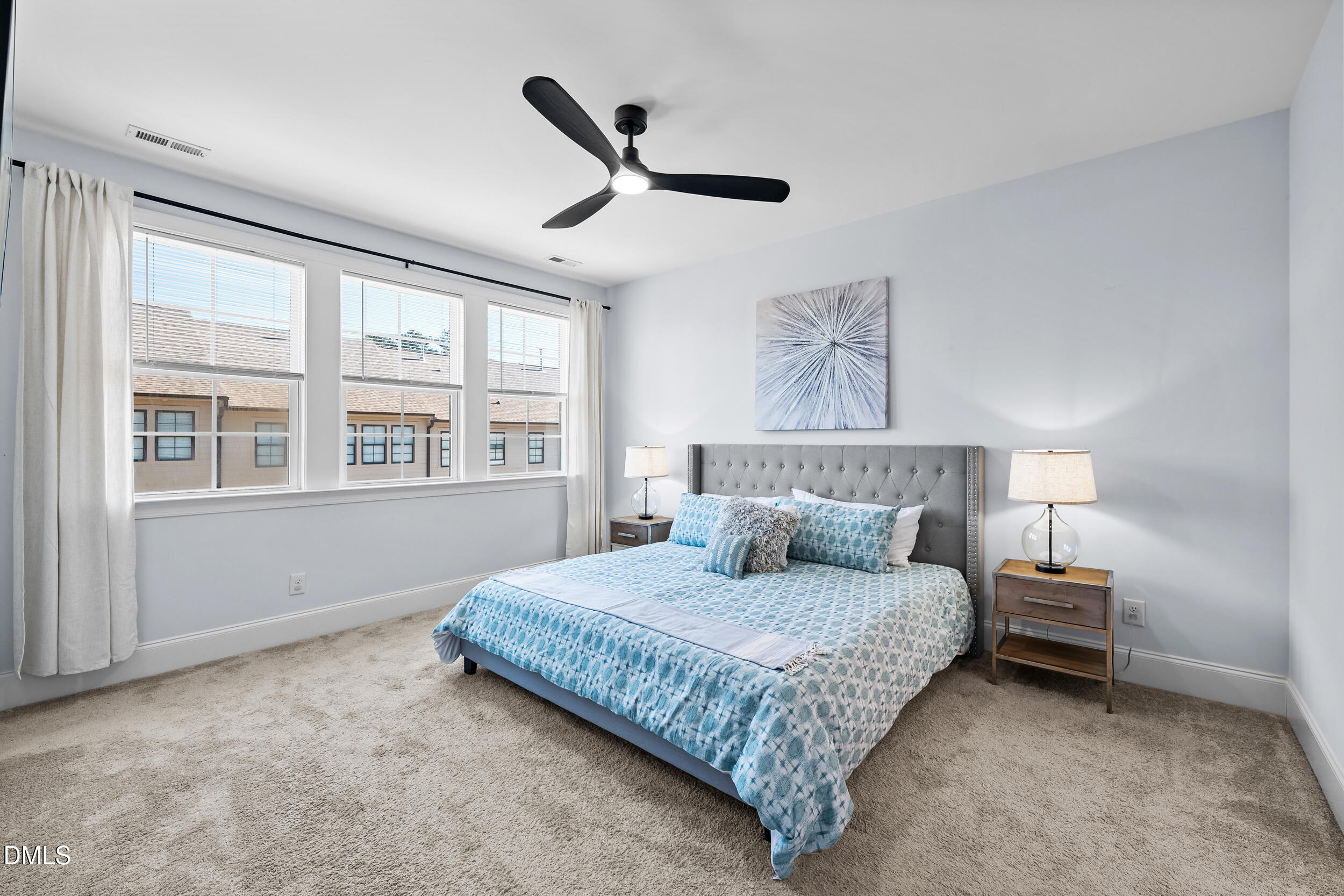 1606 Wooster Street Raleigh, NC 27607 - Photo 17 of 26 a bedroom with a bed and a large window