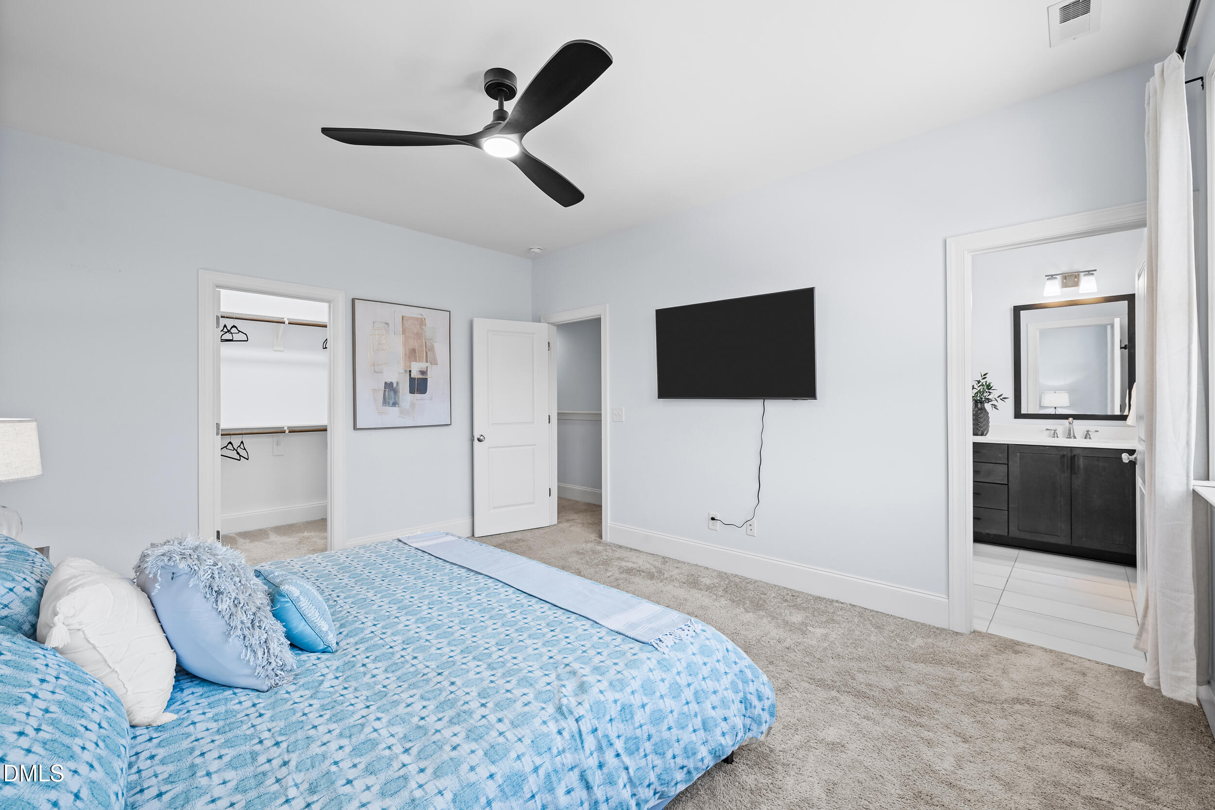 1606 Wooster Street Raleigh, NC 27607 - Photo 18 of 26 a bedroom with a bed and a flat screen tv
