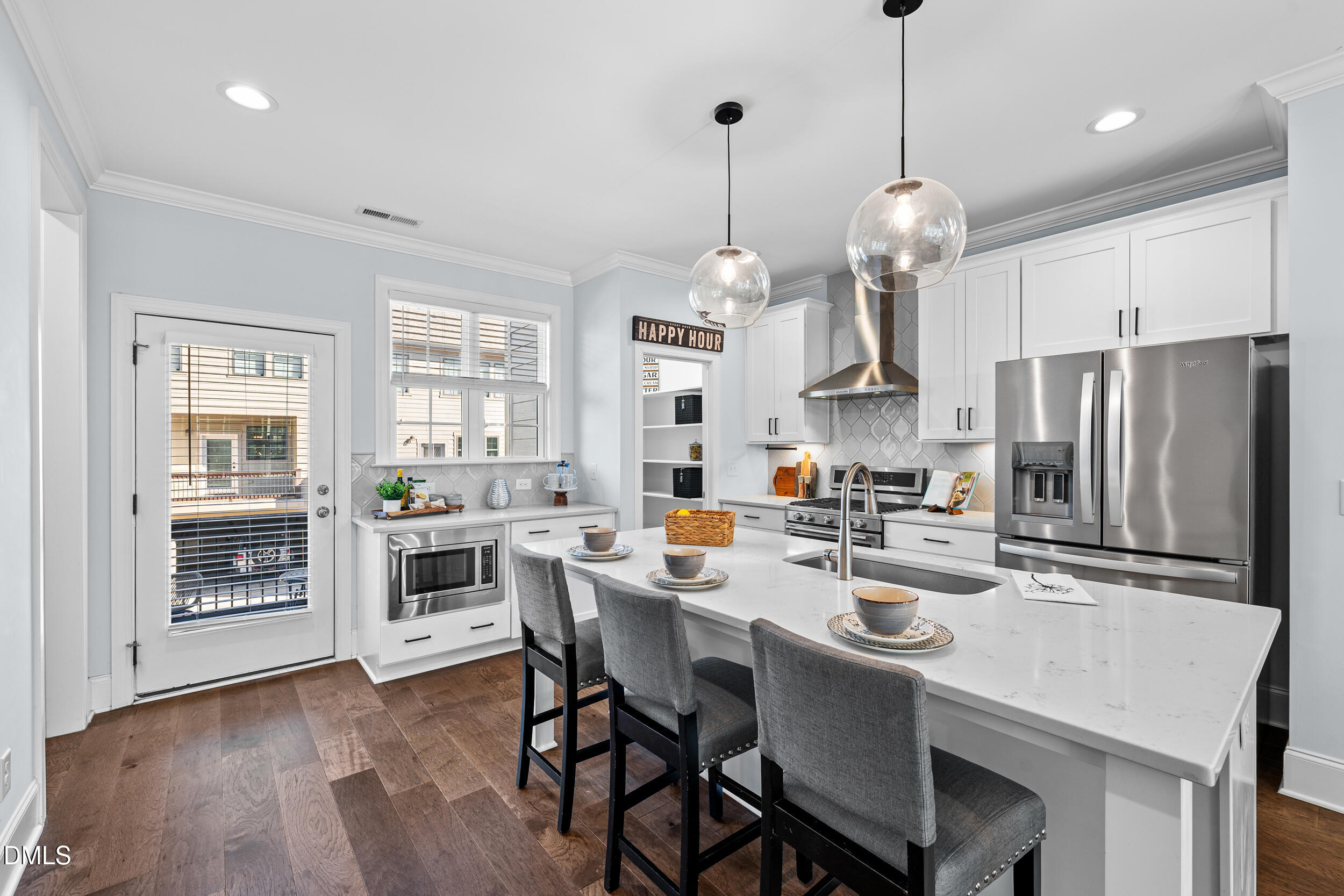 1606 Wooster Street Raleigh, NC 27607 - Photo 9 of 26 a kitchen with stainless steel appliances a dining table chairs stove and refrigerator