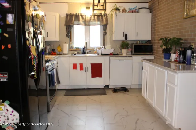 a view of a kitchen with appliances