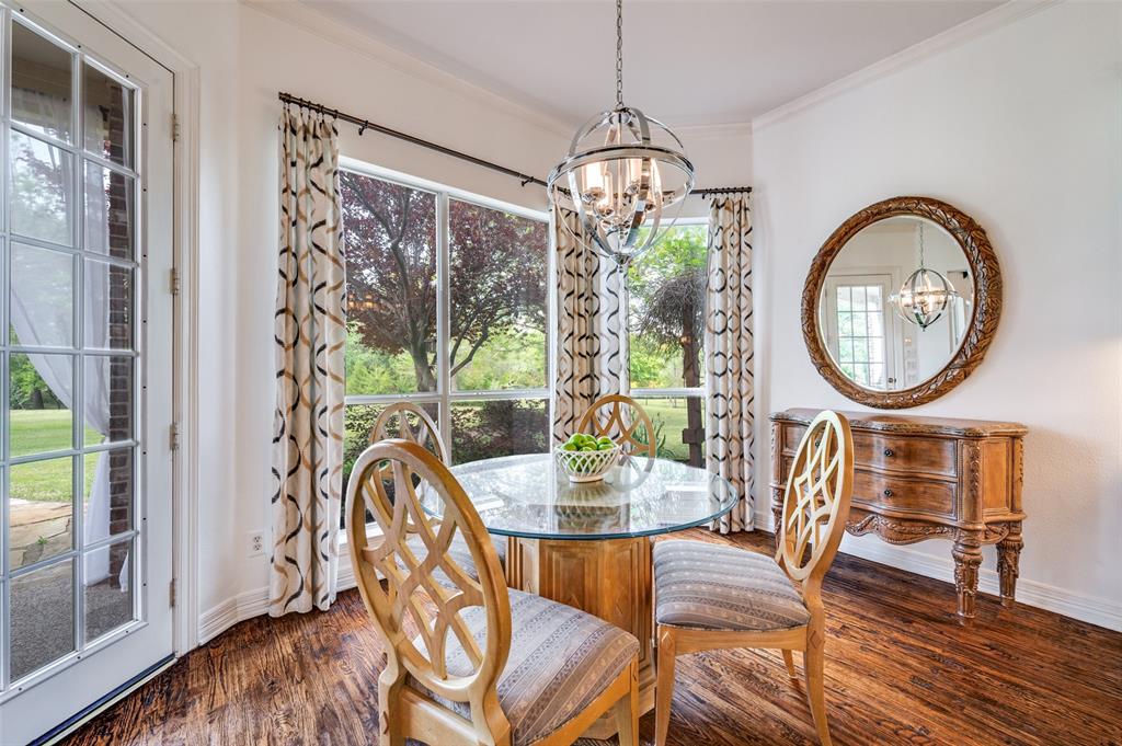 2841 Winding Creek Road Prosper, TX 75078 - Photo 11 of 40 a view of a dining room with furniture a chandelier and wooden floor