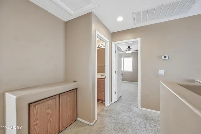 a view of a hallway with some storage and utility room