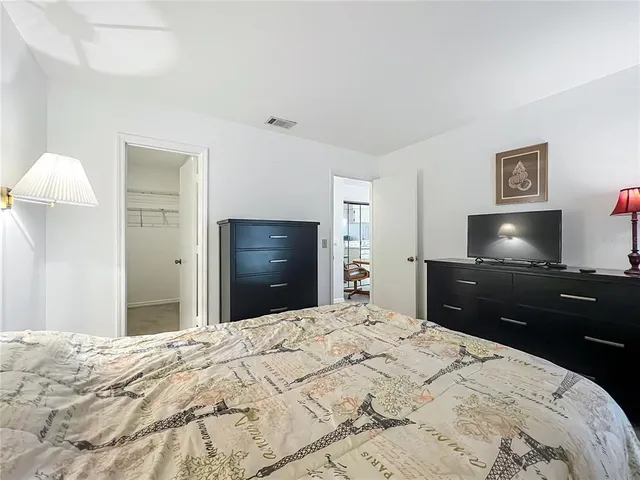 a bedroom with a bed and a flat screen tv in it