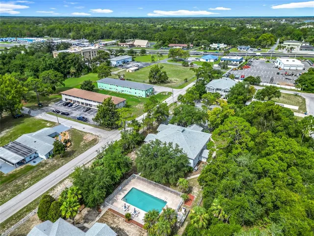an aerial view of residential houses with outdoor space and street view
