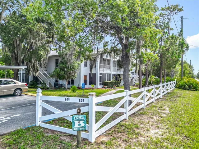 a view of a house with pool and chairs