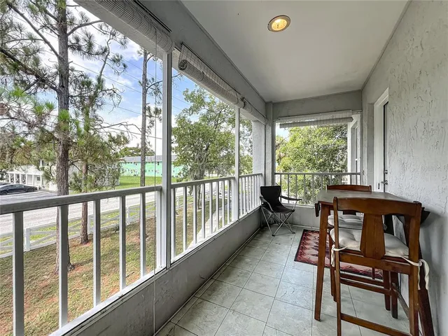 a view of a chairs and table in a balcony