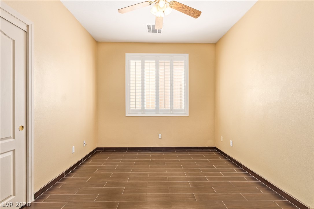 1477 Rancho Ridge Drive Henderson, NV 89012 - Photo 35 of 46 A quiet space boasts wood-look tile flooring and a ceiling fan for comfort.