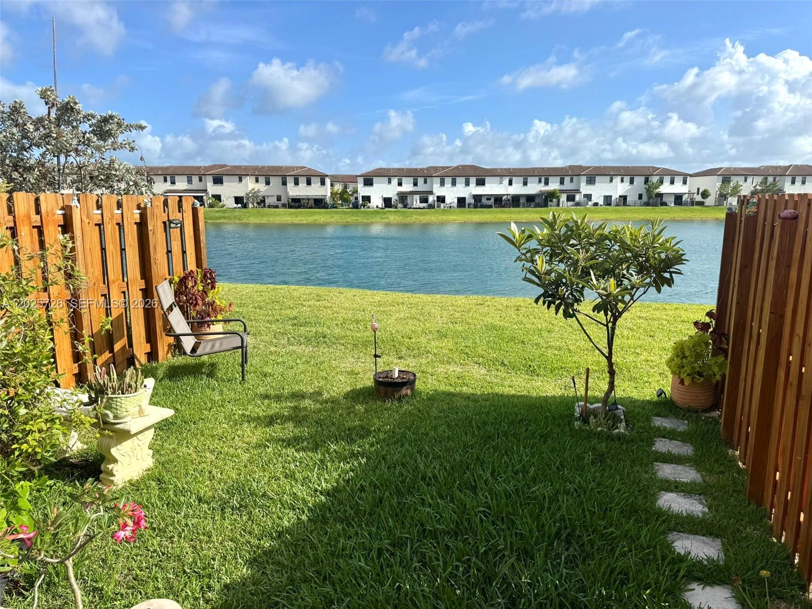 10020 Southwest 228th Terrace Miami, FL 33190 - Photo 22 of 22 a view of a lake with a big yard