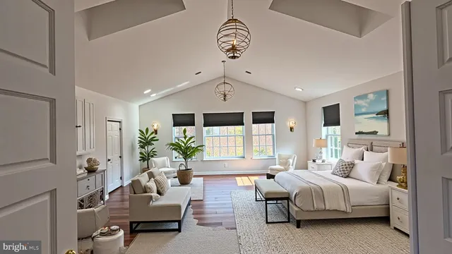a spacious bedroom with a bed couch and windows