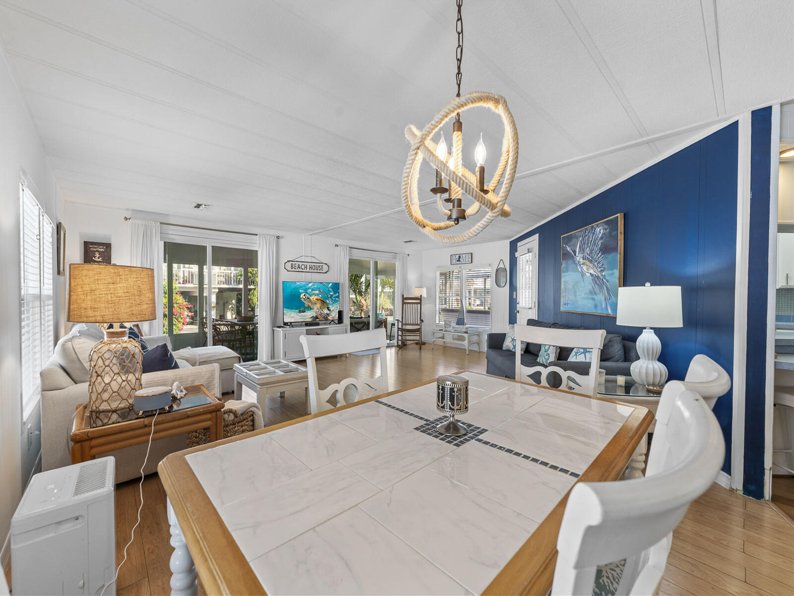 806 South Jade Drive Key Largo, FL 33037 - Photo 5 of 37 a living room with dining table a couch and a chandelier