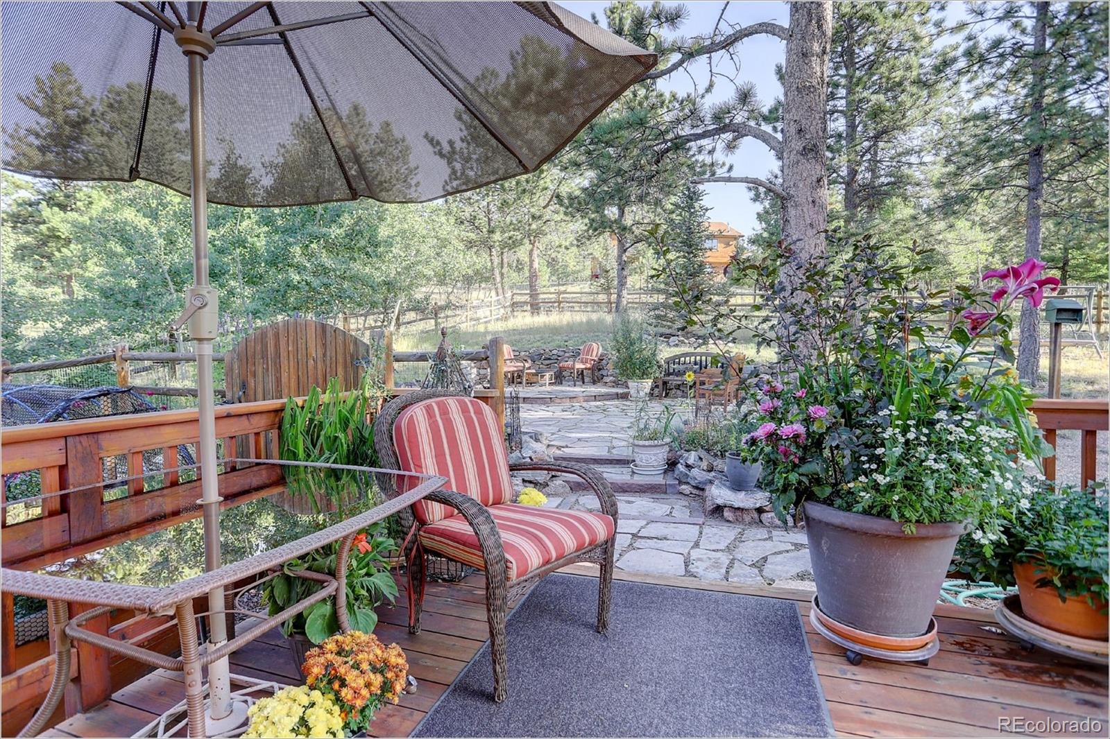 109 Royal Ridge Drive Bailey, CO 80421 - Photo 2 of 39 a outdoor living space with furniture and plants