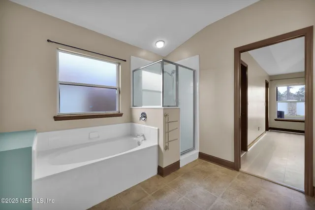 a bathroom with a bathtub and a shower