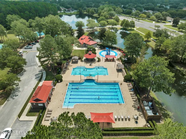 an aerial view of a yard swimming pool and outdoor seating