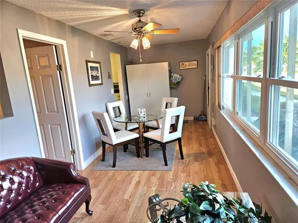 a dining room with wooden floor and a chandelier