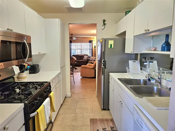 a kitchen with a sink and a stove top oven