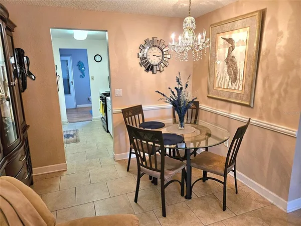 a view of a dining room with furniture and chandelier