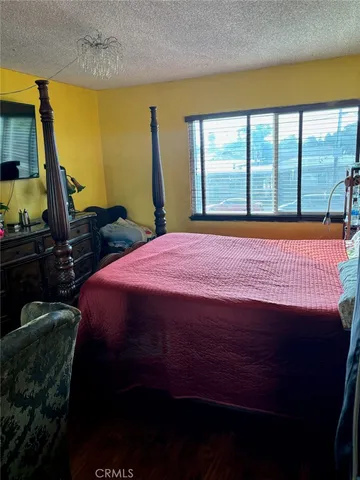a bed sitting in a bedroom next to a window