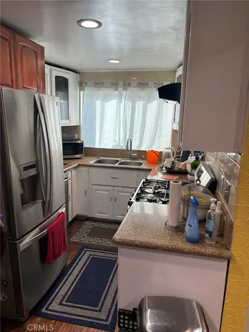 a kitchen with a sink stove and refrigerator