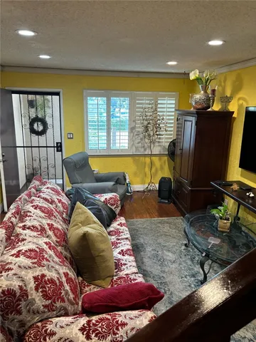 a living room with couches and flat screen tv