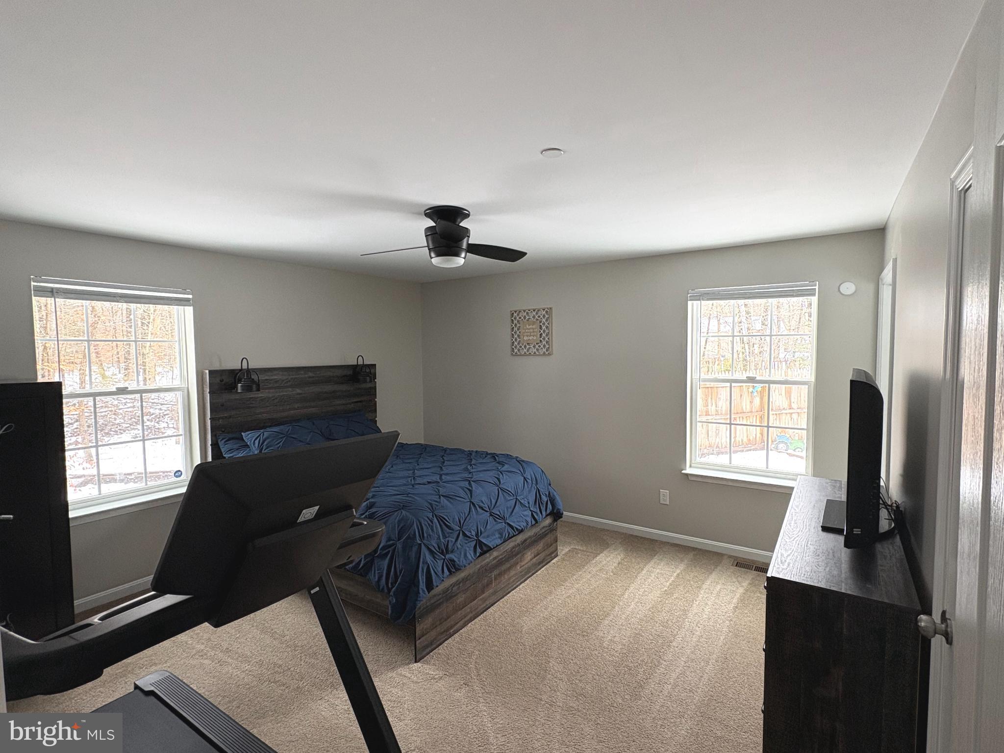 148 East Step Road Chestertown, MD 21620 - Photo 28 of 46 a bedroom with a bed and a flat tv screen on the dresser