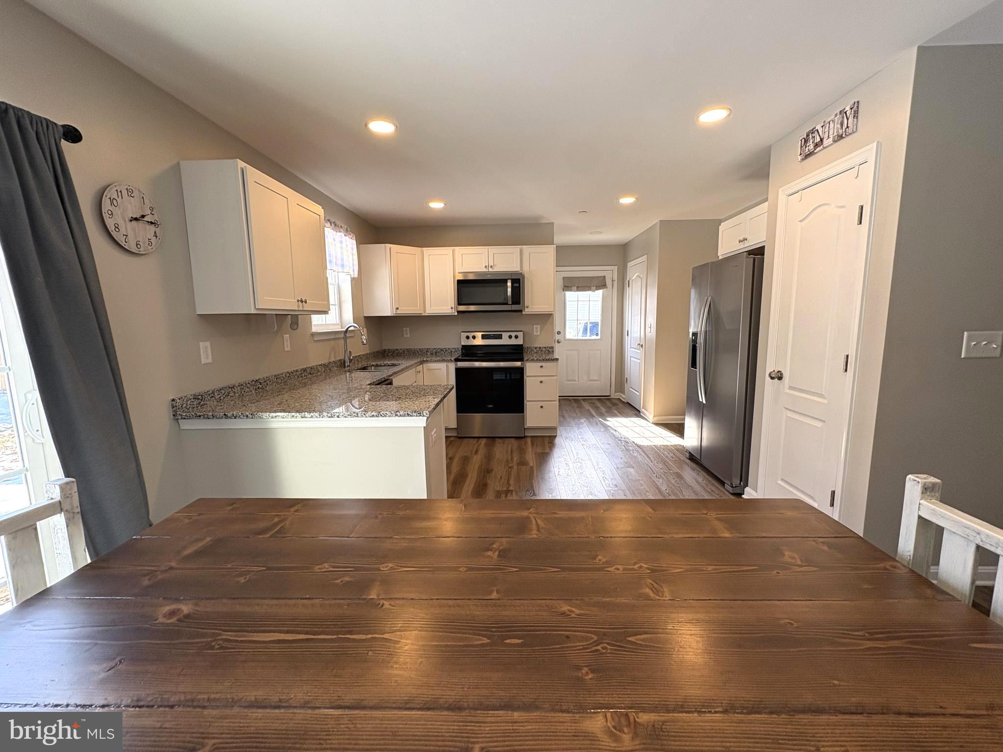 148 East Step Road Chestertown, MD 21620 - Photo 10 of 46 a kitchen with granite countertop a stove and a refrigerator