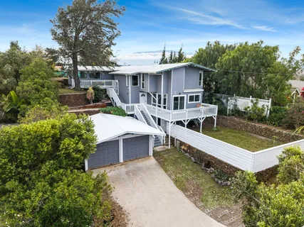 a view of a house with pool and chairs