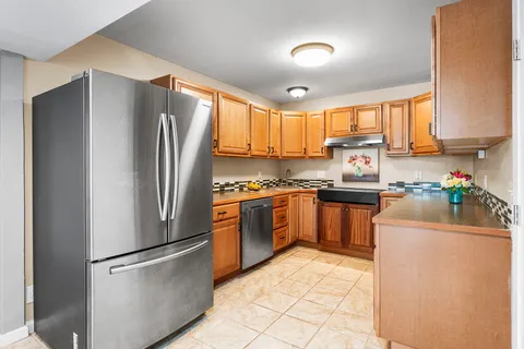 a kitchen with a refrigerator sink and cabinets