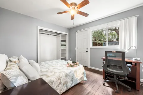 a bedroom with a bed and a chandelier
