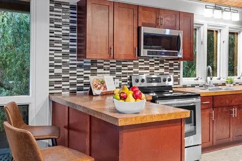 a kitchen with a sink stove and microwave
