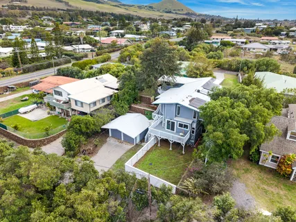 an aerial view of a house with a garden and lake view