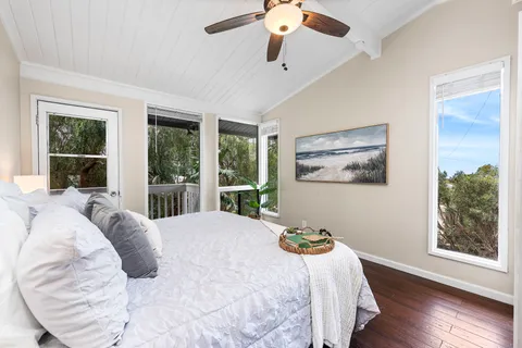 a bedroom with bed and glass window