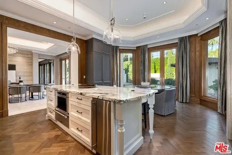 a kitchen with a stove and a large window