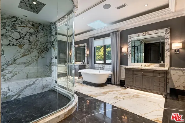 a bathroom with a sink a bathtub and a shower