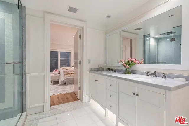a spacious bathroom with a shower sink and mirror