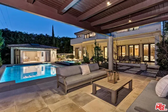 a living room with patio furniture and a wooden floor