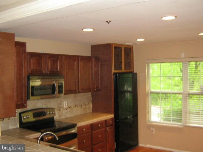3062 South Glebe Road, Unit 3062 Arlington, VA 22206 - Photo 2 of 9 a kitchen with stainless steel appliances granite countertop a refrigerator a stove top oven a sink and dishwasher