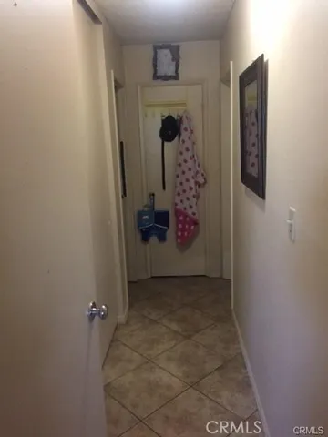 a bedroom with a bed and a flat tv screen on the dresser