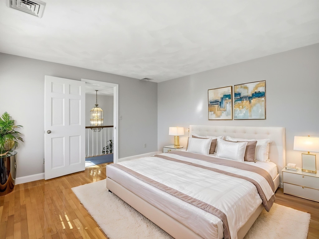 90 Blue Ridge Road North Andover, MA 01845 - Photo 14 of 26 a bedroom with a bed and a potted plant