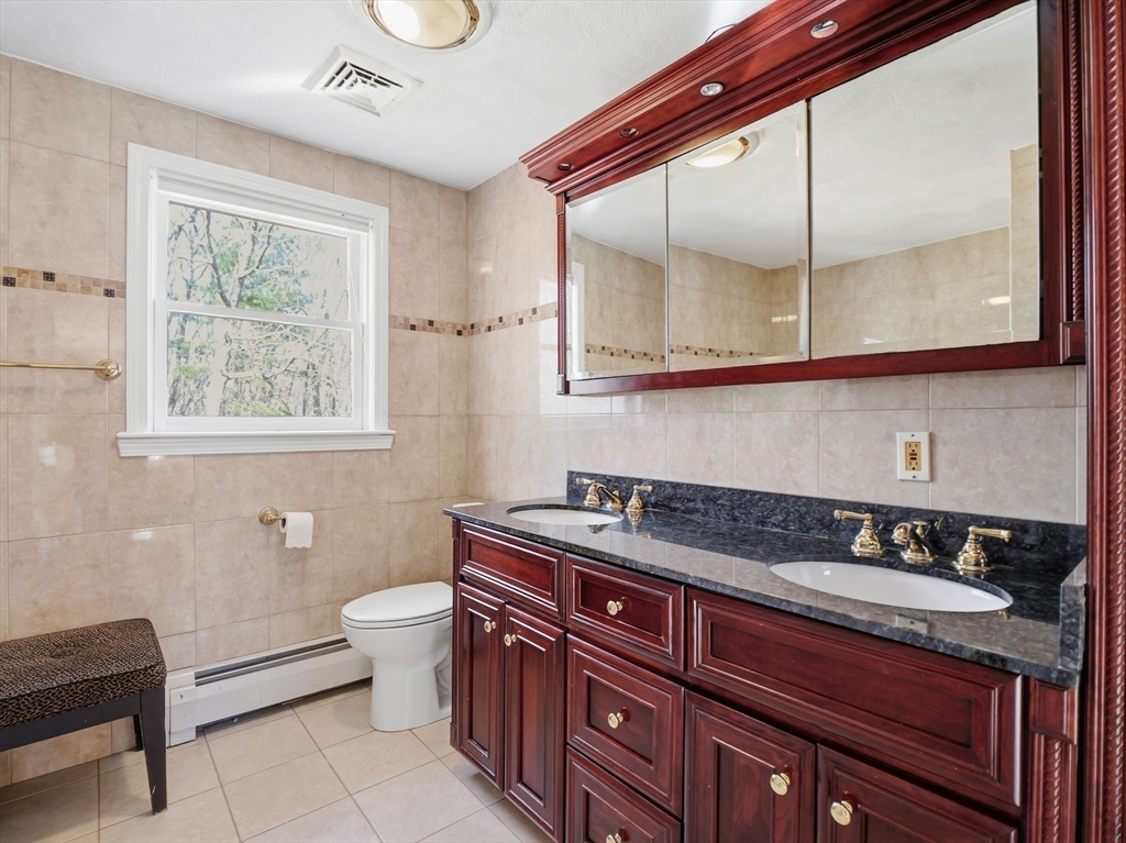 90 Blue Ridge Road North Andover, MA 01845 - Photo 18 of 26 a bathroom with a granite countertop sink a toilet a mirror and a window