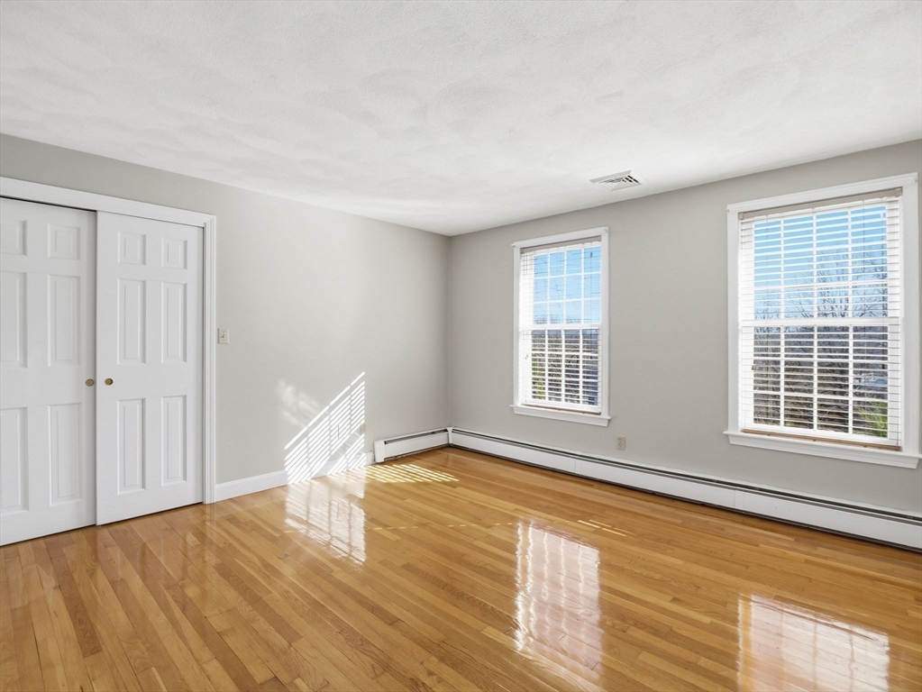 90 Blue Ridge Road North Andover, MA 01845 - Photo 21 of 26 a view of an empty room with wooden floor and a window