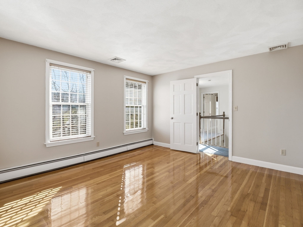 90 Blue Ridge Road North Andover, MA 01845 - Photo 22 of 26 a view of an empty room with wooden floor and a window