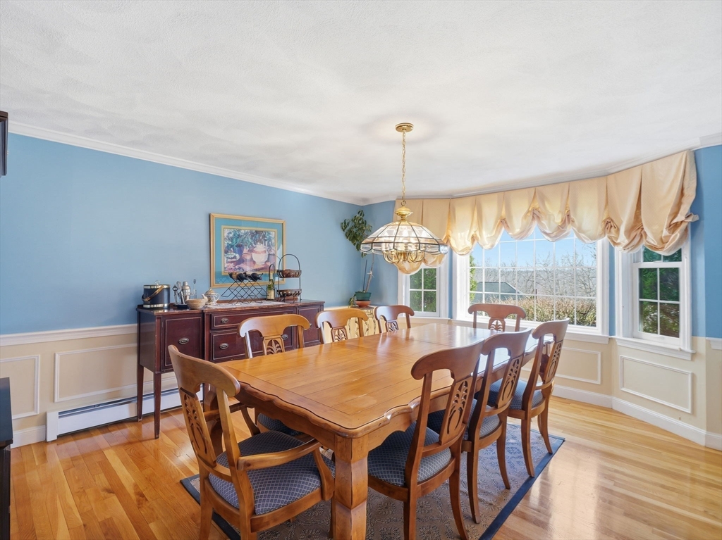 90 Blue Ridge Road North Andover, MA 01845 - Photo 8 of 26 a dining room with furniture a chandelier and wooden floor