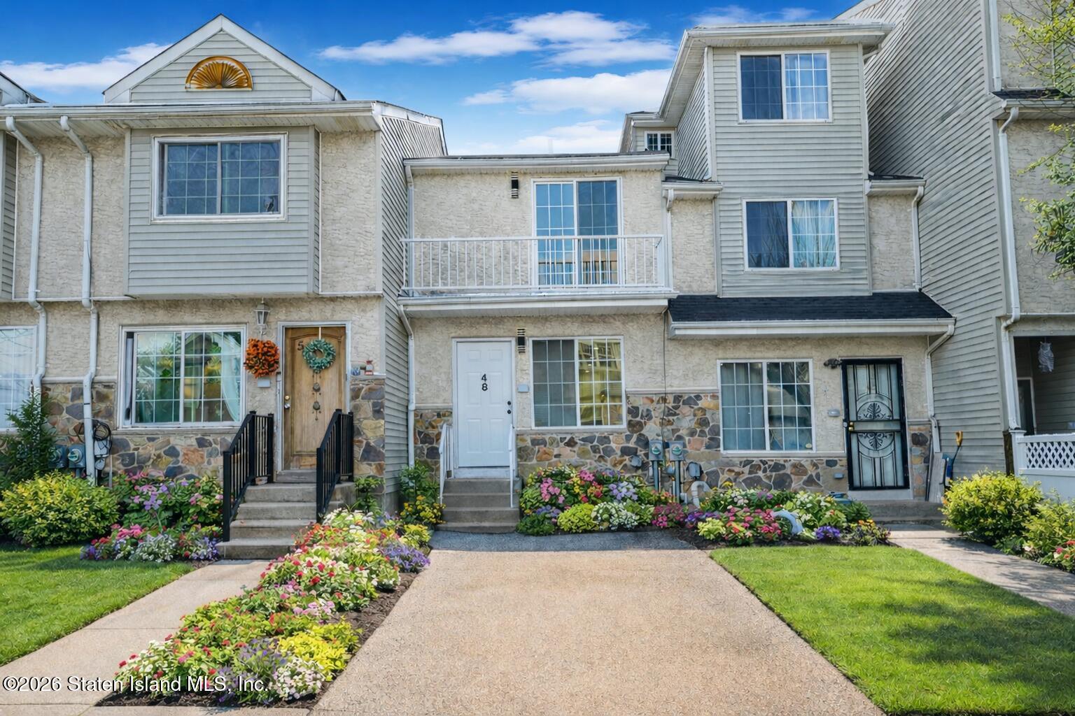48 Studio Lane Staten Island, NY 10304 - Photo 1 of 38 a front view of a house with garden