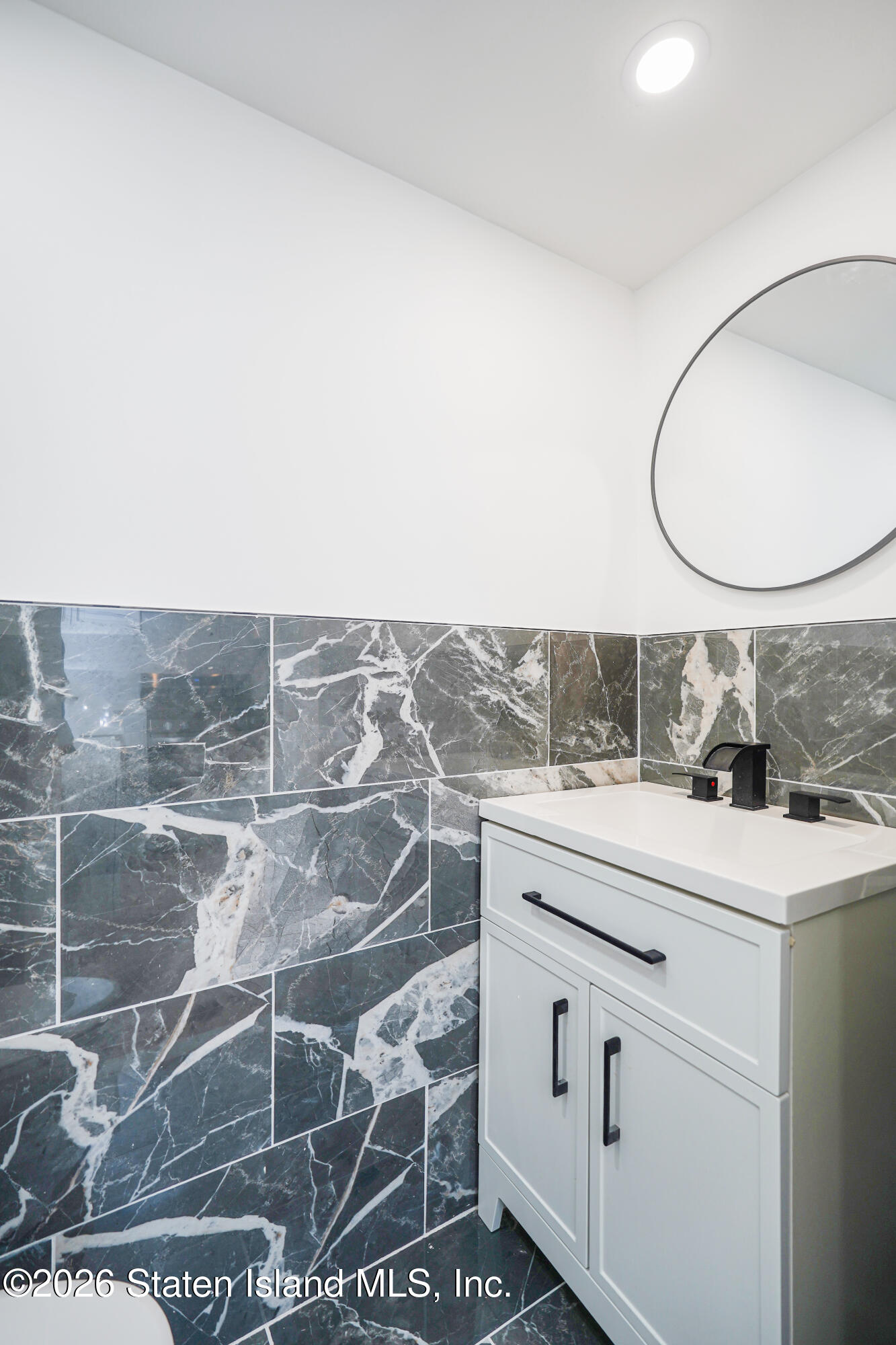 48 Studio Lane Staten Island, NY 10304 - Photo 11 of 38 a bathroom with a sink and a mirror