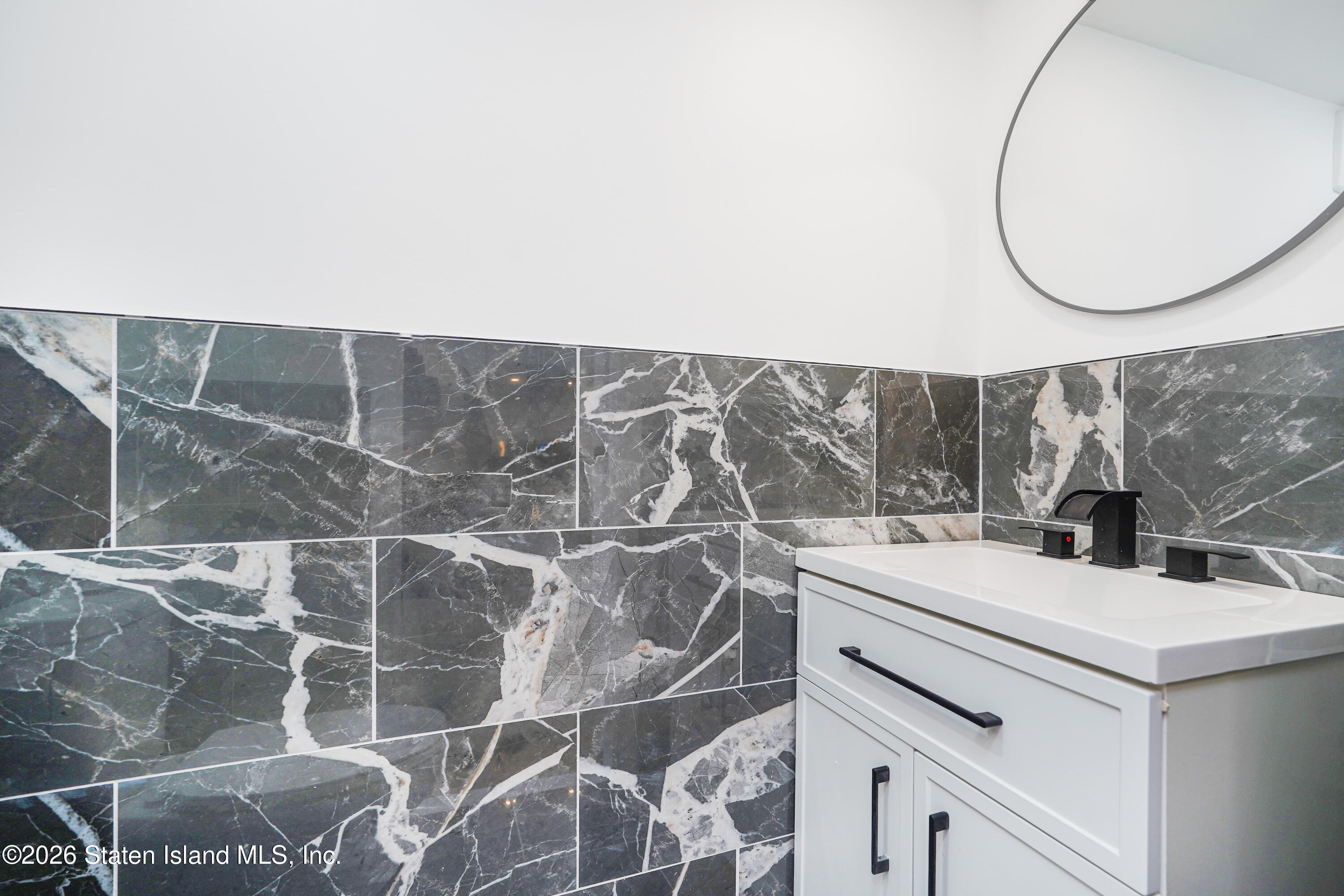 48 Studio Lane Staten Island, NY 10304 - Photo 12 of 38 a utility room with a sink and a mirror
