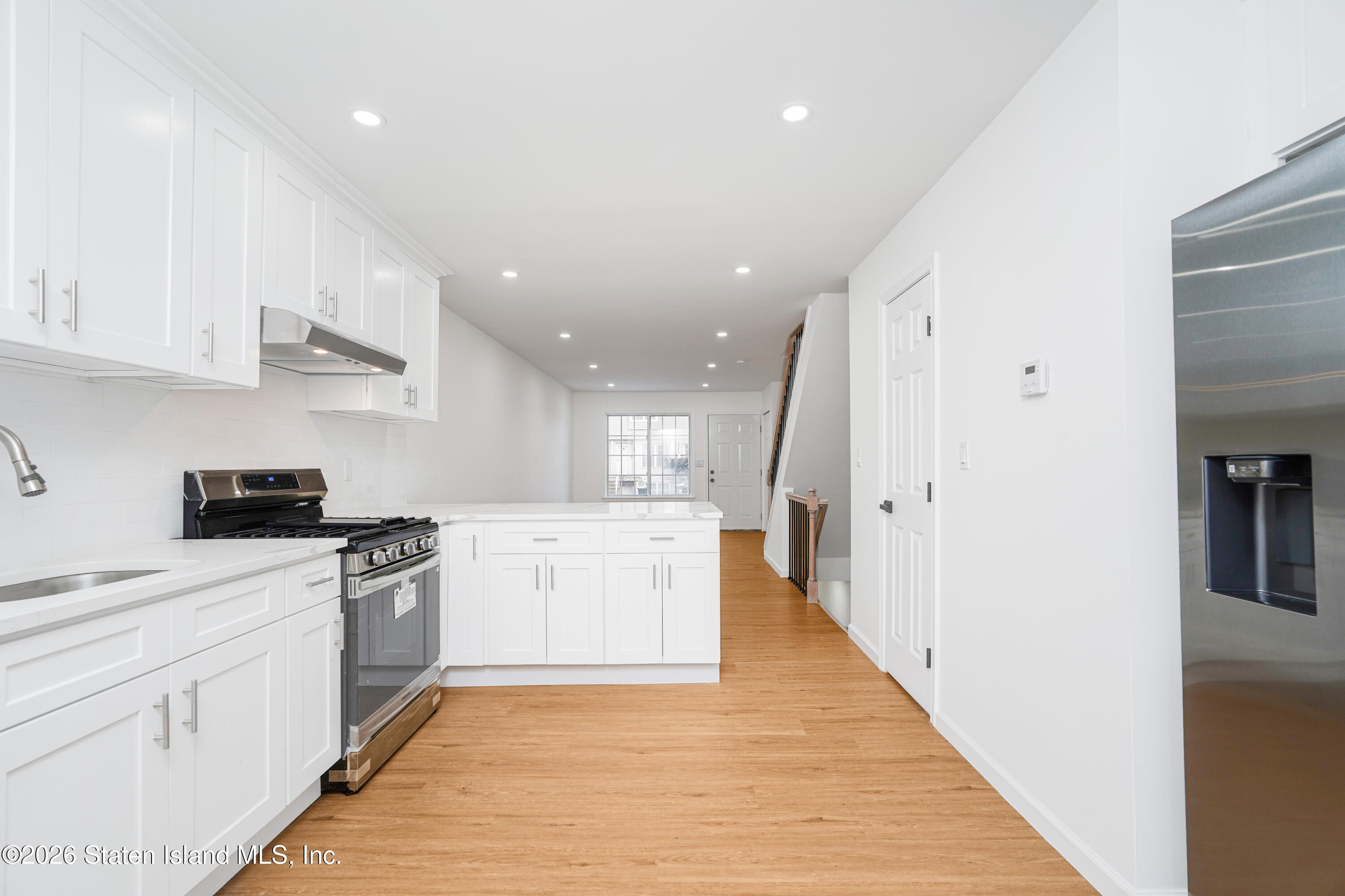 48 Studio Lane Staten Island, NY 10304 - Photo 14 of 38 a kitchen with white cabinets and appliances